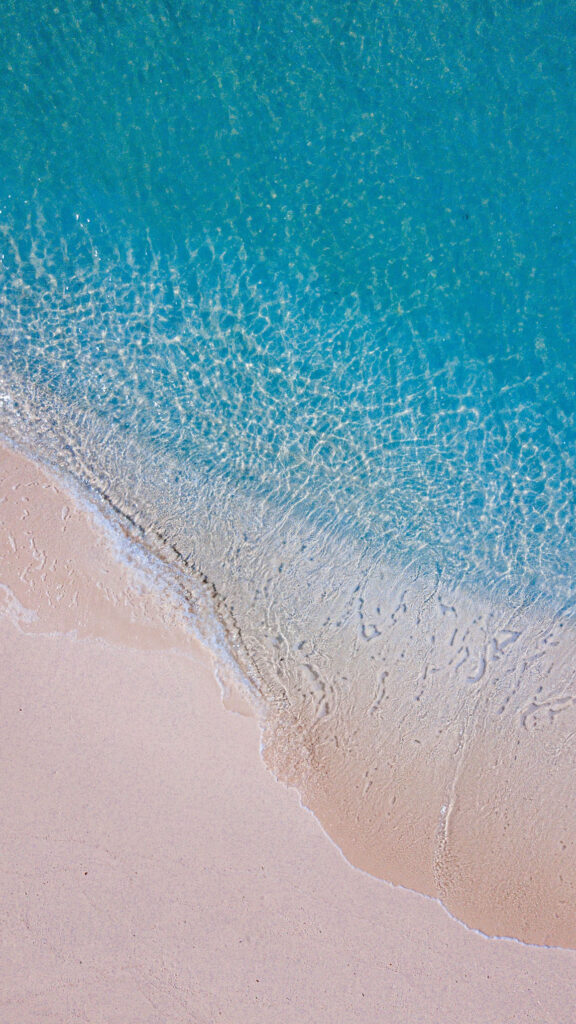 Serene Beach Wallpaper: Gentle Waves & Soft Sandy Shore Background