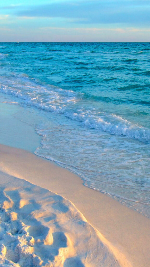 Serene Beach Wallpaper: Gentle Waves & Sunlit Sand Background