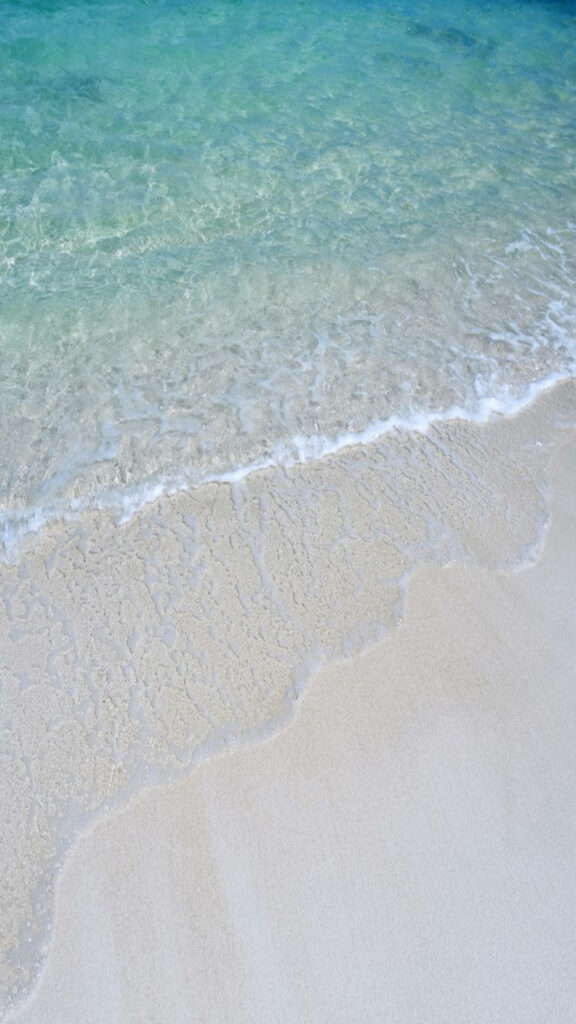 Calm Beach Scene: Gentle Waves & Pristine Turquoise Waters Background Wallpaper