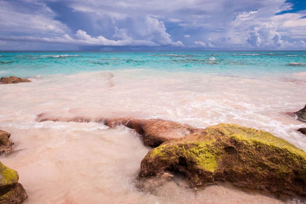 Serene Beach Wallpaper: Pink Sand, Turquoise Waters & Vibrant Rocks