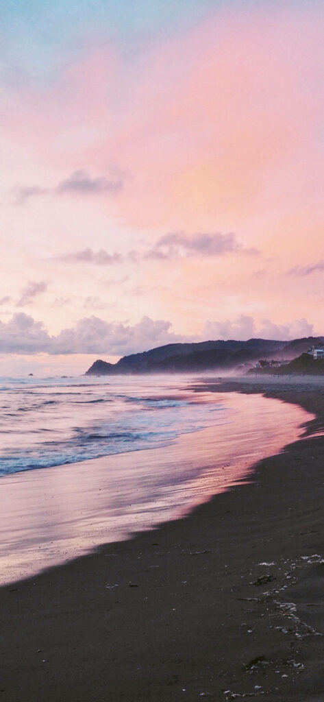 Serene Beach Sunset Wallpaper: Gentle Waves & Pink Sky Background