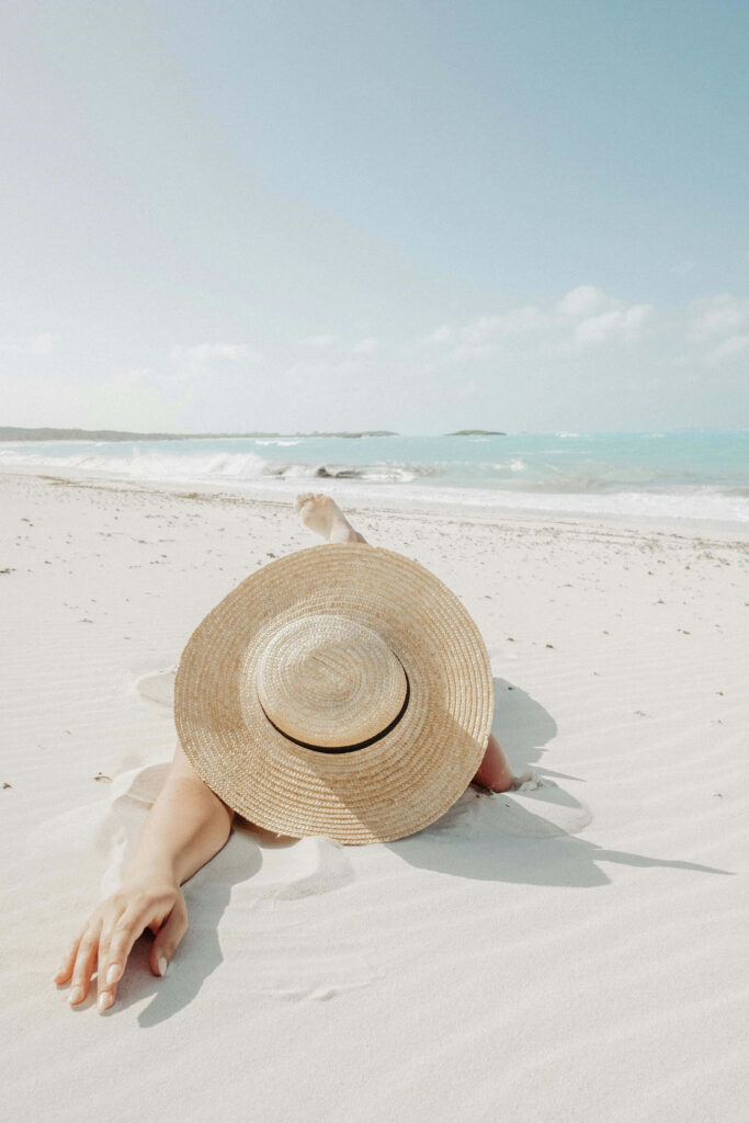 Serene Beach Wallpaper: Relaxing on Soft Sand Under Blue Sky