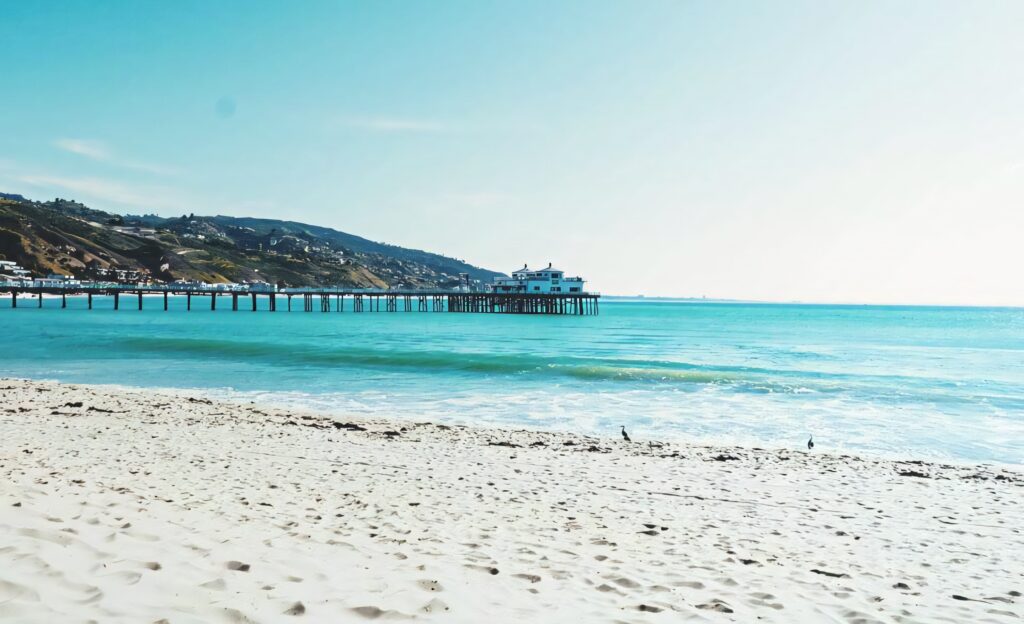 Serene Beach Wallpaper: Turquoise Water & Scenic Pier Background
