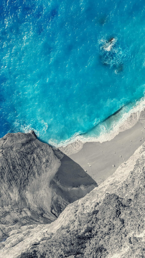Serene Beach Wallpaper: Turquoise Waves & Dramatic Cliffs Background