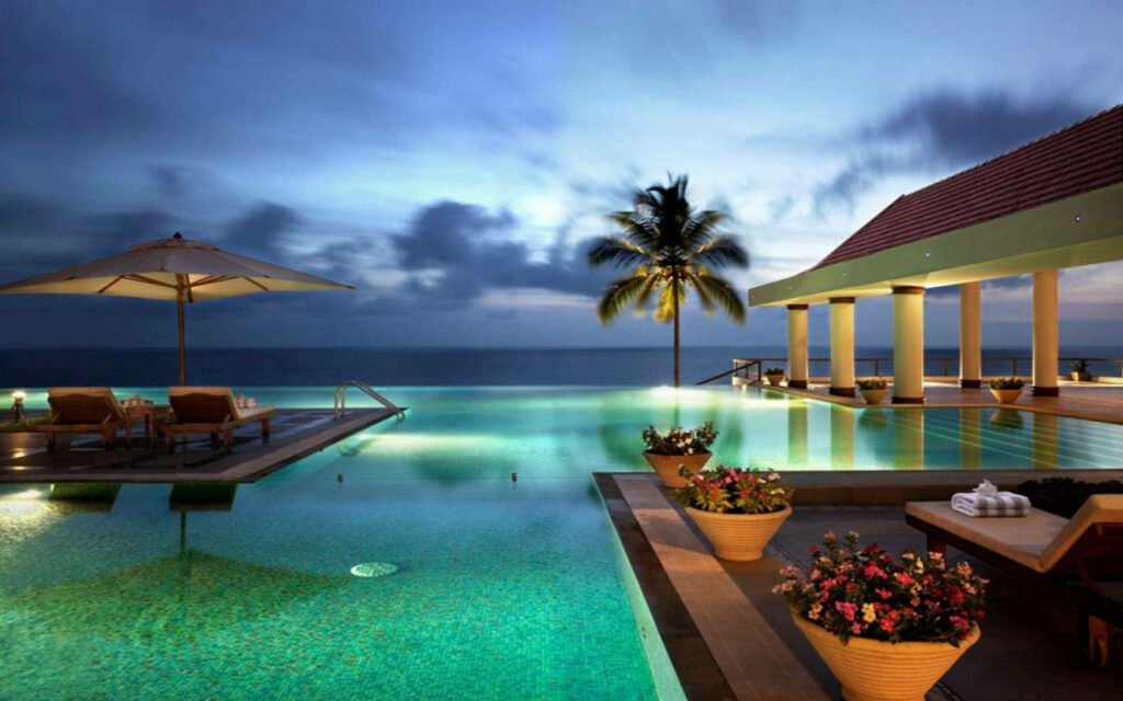 Serene Beachfront Sunset Wallpaper with Infinity Pool & Palm Trees