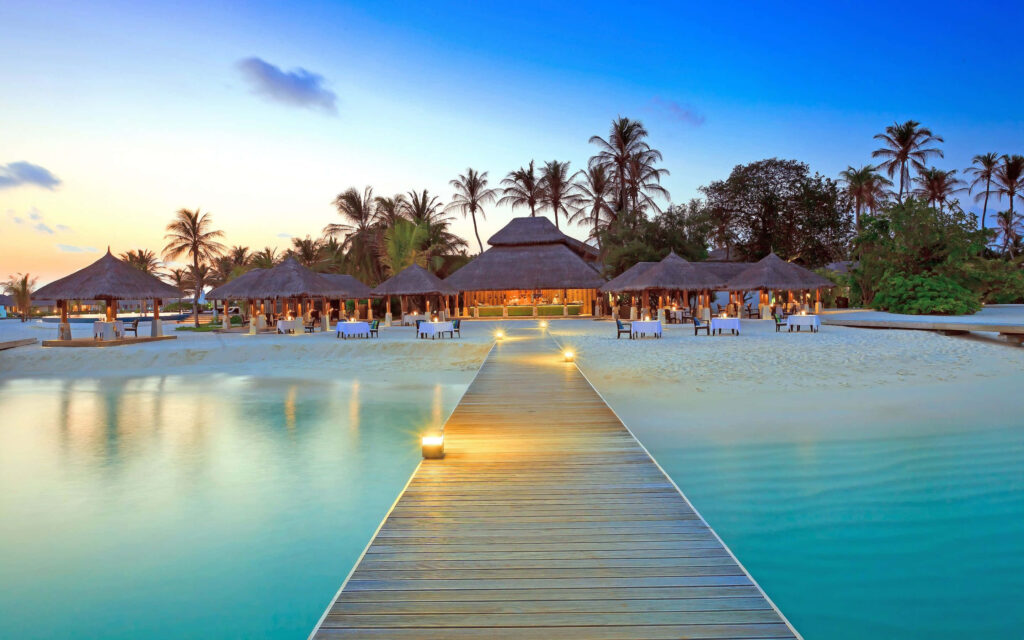 Serene Beach Resort Sunset: Tropical Paradise Wallpaper Background
