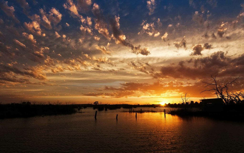 Dreamy Dawn: Captivating Lake Serenity Amidst Heavenly Skies Wallpaper