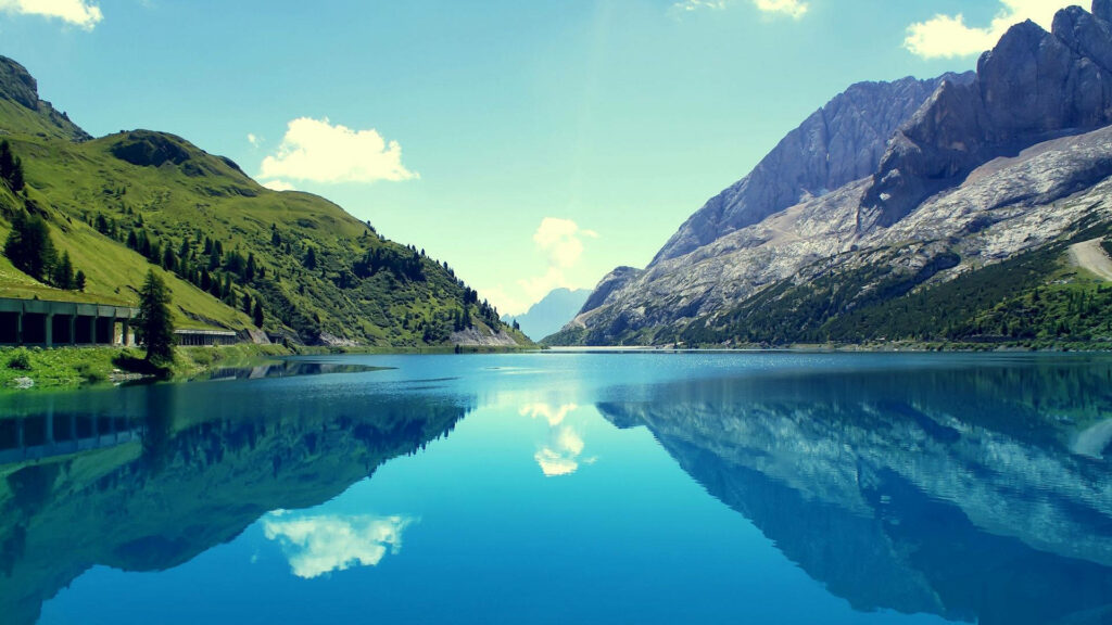 Serene Beauty of Nature: HD Landscape Wallpaper of Green Mountains Encompassing a Peaceful Blue Lake - Background Photo