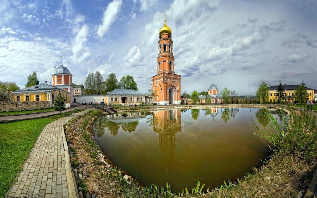 Tranquil Bell Tower Wallpaper: Lush Greenery & Serene Reflections