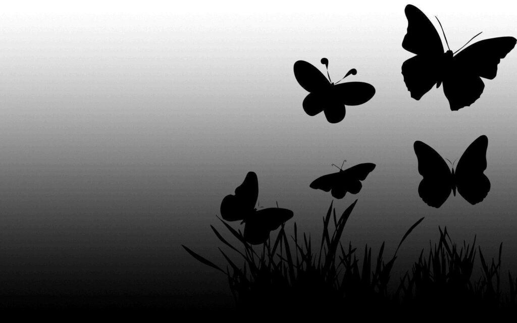 Elegant Black Butterfly Graphics on Gradient Grass Background Wallpaper