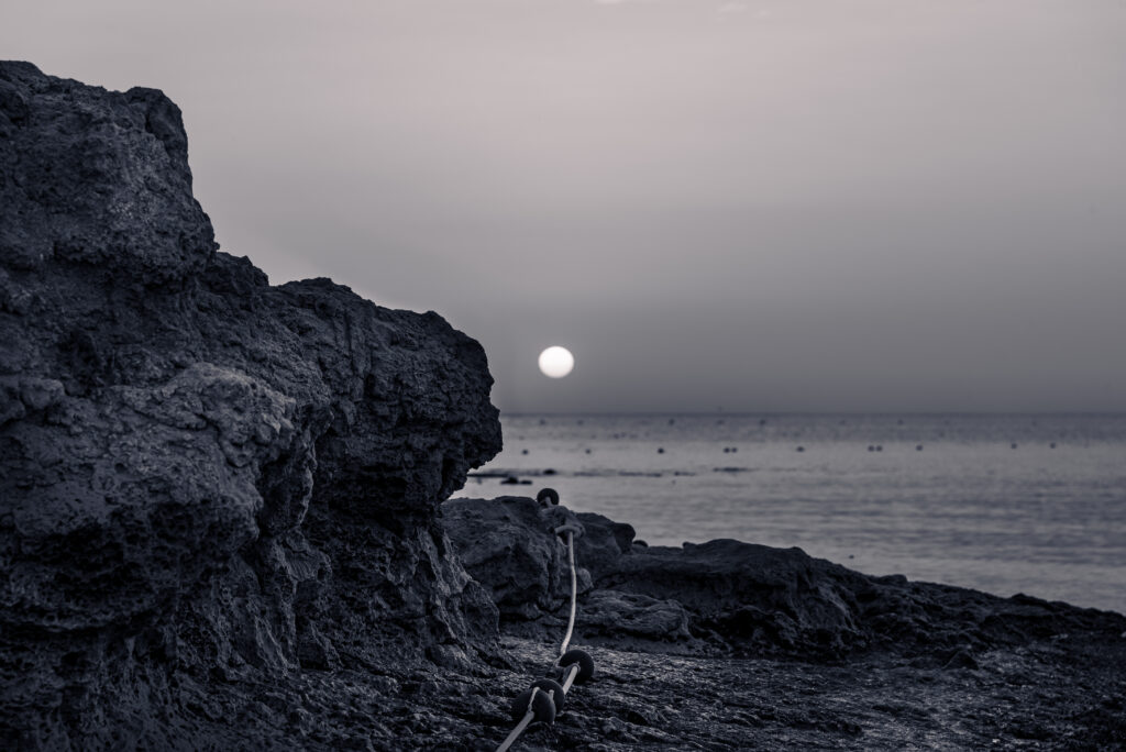 Tranquil Black and White Wallpaper: Moonlit Rocks by the Sea