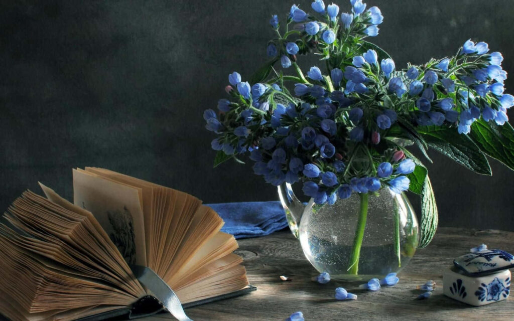 Elegant Still Life: Blue Bell Flowers & Open Book on Dark Background Wallpaper