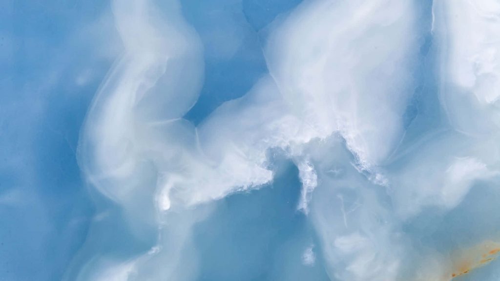 Abstract polished blue onyx wallpaper with soft icy white and cerulean swirls for serenity