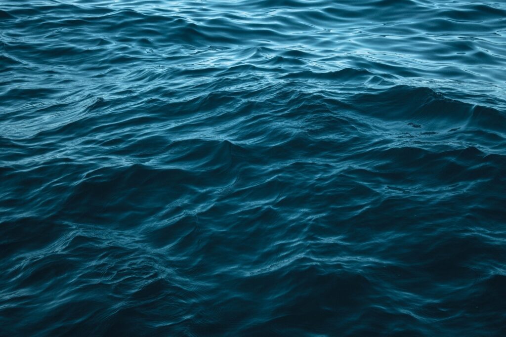 Calming sea wallpaper with gentle blue waves and ripples showing water depth and movement
