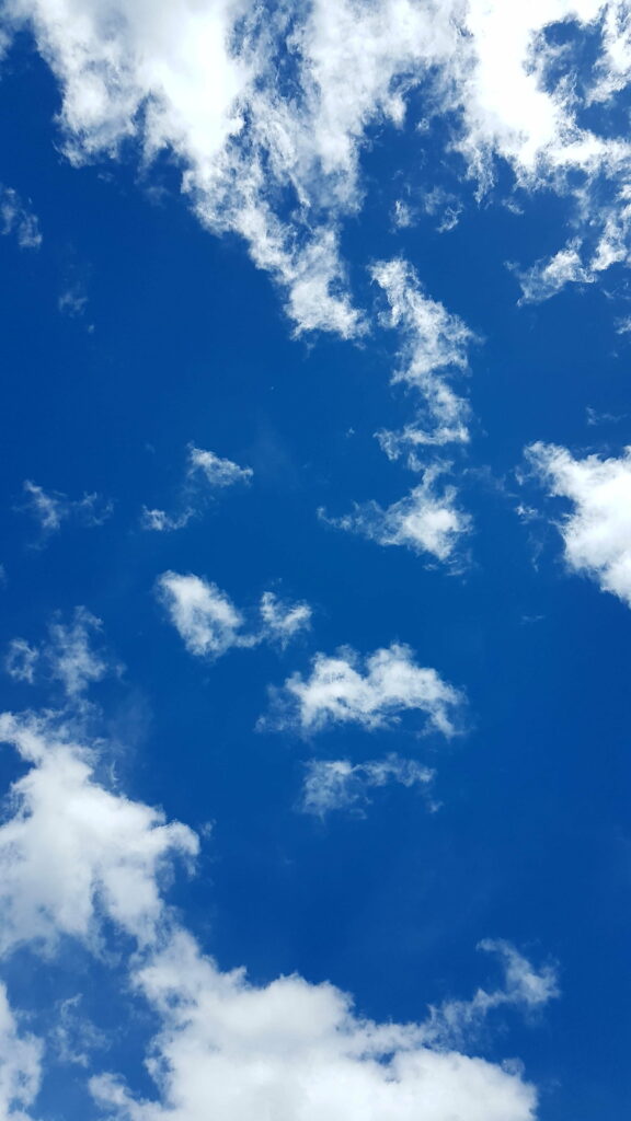 Serene HD Blue Sky Wallpaper with Fluffy White Clouds
