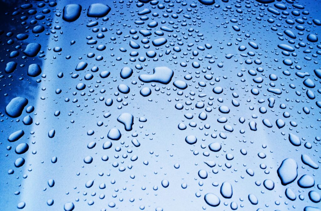 Calm Blue Water Droplets on Smooth Glass - Textured Wallpaper Background