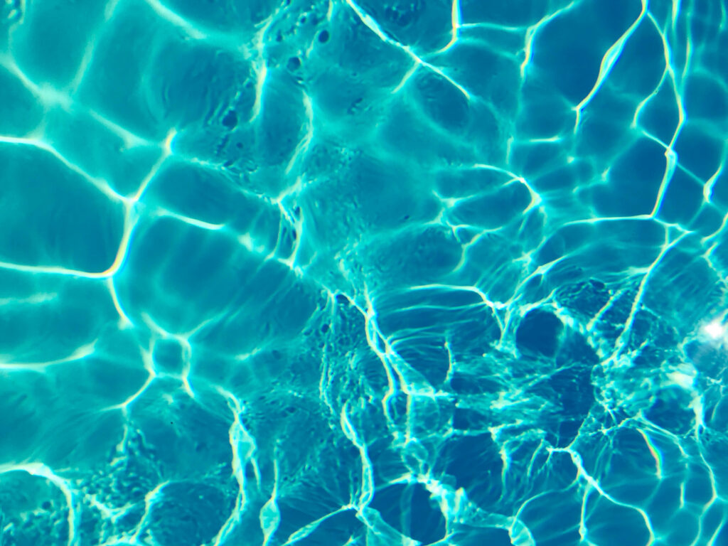 Serene Blue Water Wallpaper: Calm Ripples & Gentle Light Reflections