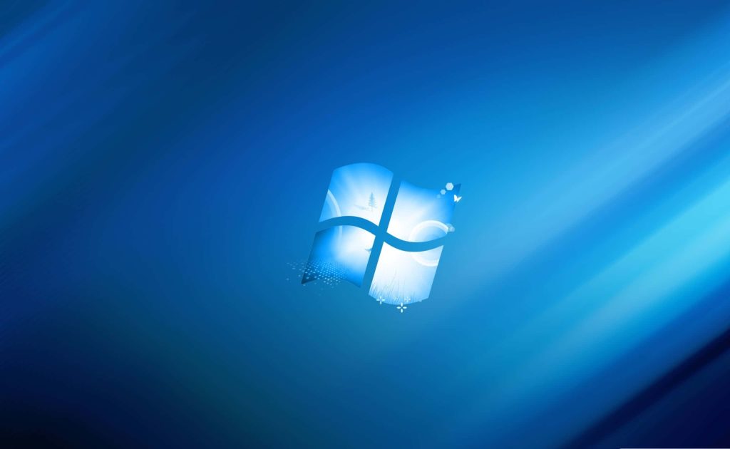 Blue Windows wallpaper with glowing logo pine tree butterflies and abstract flowers background