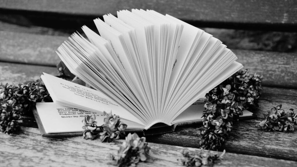 Timeless Book Wallpaper: Rustic Table & Serene Floral Background