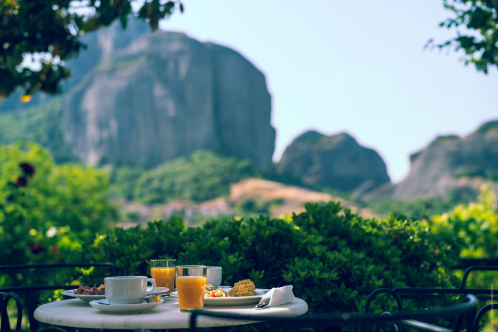 Serene Breakfast Setup with Juice, Coffee & Pastries in Nature Wallpaper