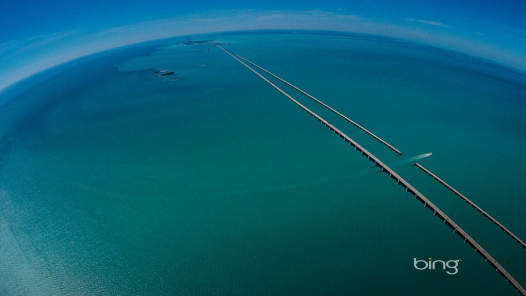 Aerial view of Seven Mile Bridge over turquoise Florida Keys ocean under clear blue sky wallpaper