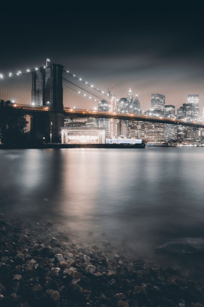 Serene Brooklyn Bridge Night Wallpaper: City Lights Reflection Background
