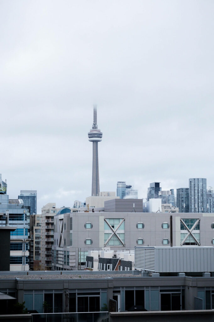 Serene Toronto Wallpaper: CN Tower in Misty Urban Skyline