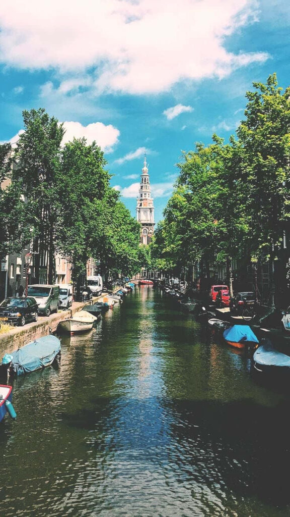Serene Canal Wallpaper: Lush Greenery & Charming Buildings