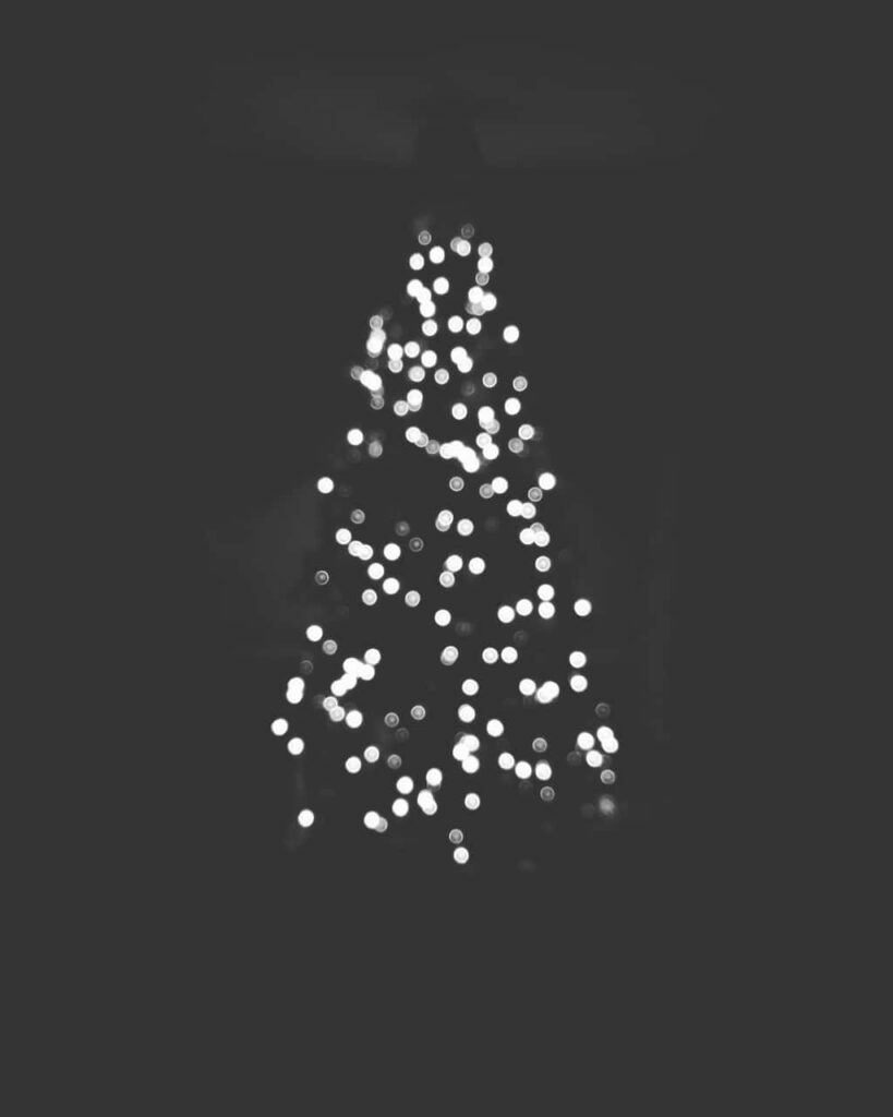Serene Christmas Tree Wallpaper: Glowing Lights on Dark Background