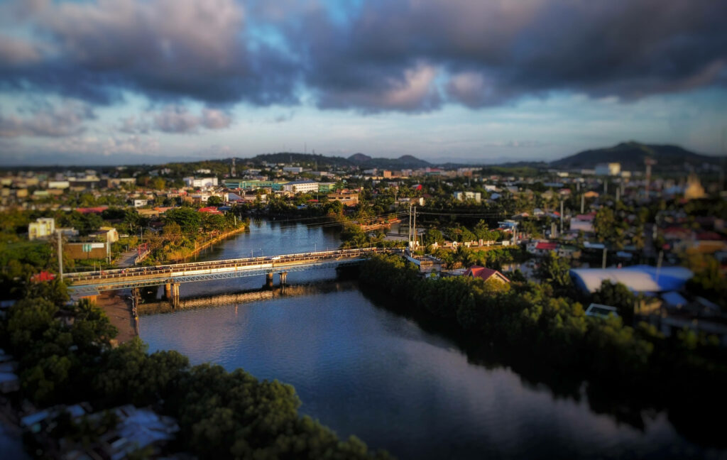 Serene Cityscape: Bridge Over Calm River - Stunning Wallpaper Background