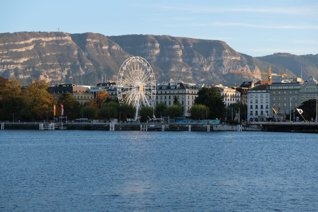 Coastal Cityscape Wallpaper: Ferris Wheel & Scenic Mountain View