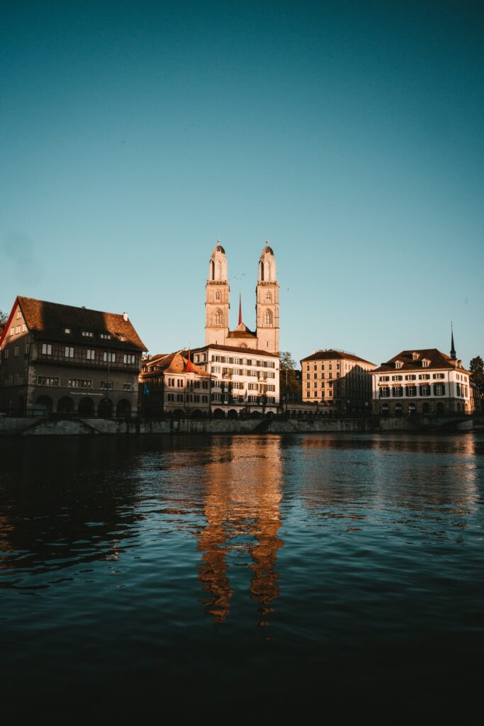 Serene Urban Cityscape Wallpaper: Historic Towers & Calm Waters