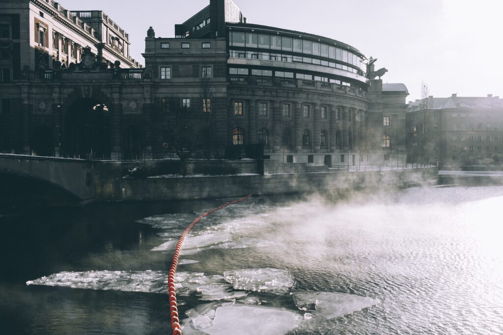 Tranquil Cityscape Wallpaper: Historic Building by Icy River