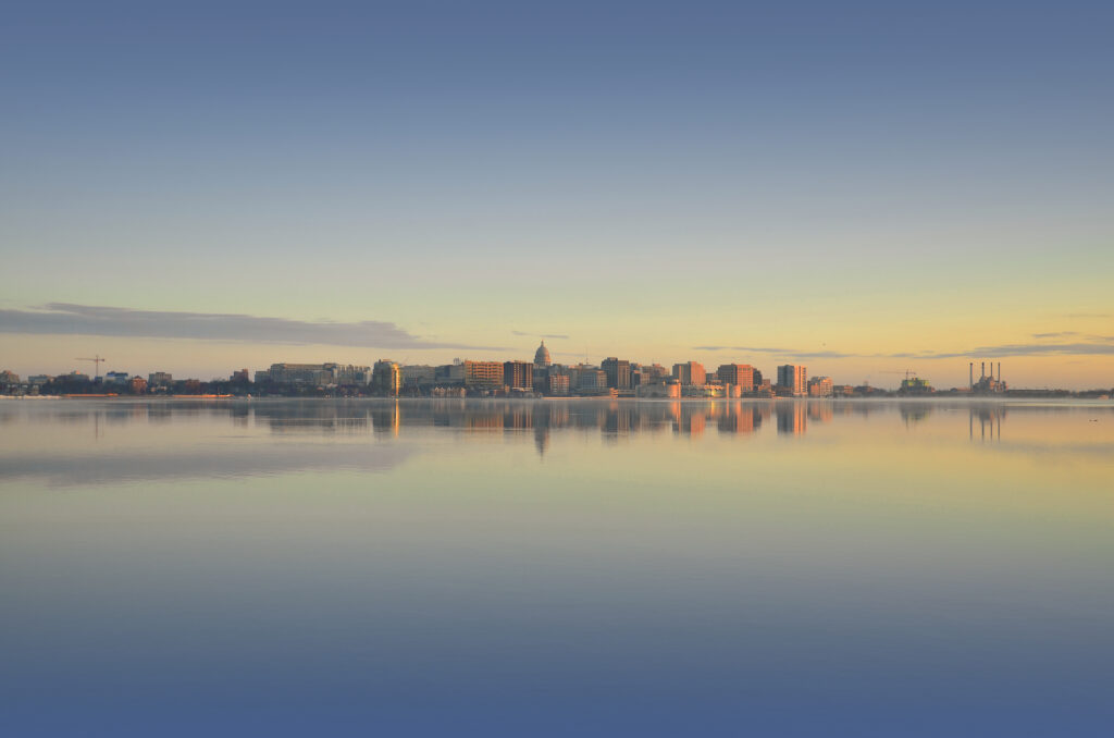 Tranquil Cityscape Wallpaper: Modern Buildings Reflected in Calm Water