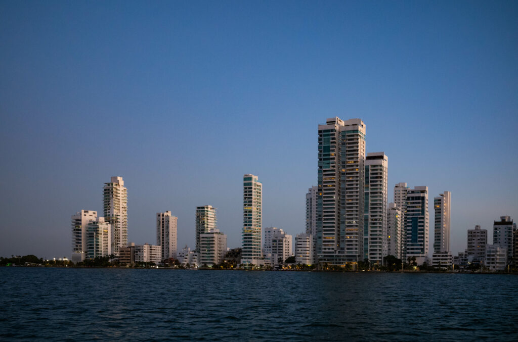 Serene Cityscape Wallpaper: Modern High-Rises by Calm Sea