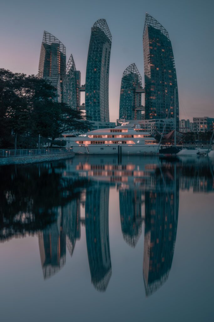 Serene Cityscape Wallpaper: Modern Skyscrapers & Elegant Lake Reflections