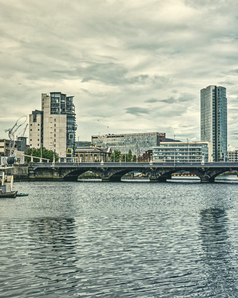 Serene Cityscape Wallpaper: River, Bridge & Architectural Harmony