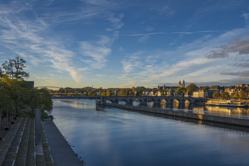 Serene City River Wallpaper with Elegant Bridge and Charming Skyline