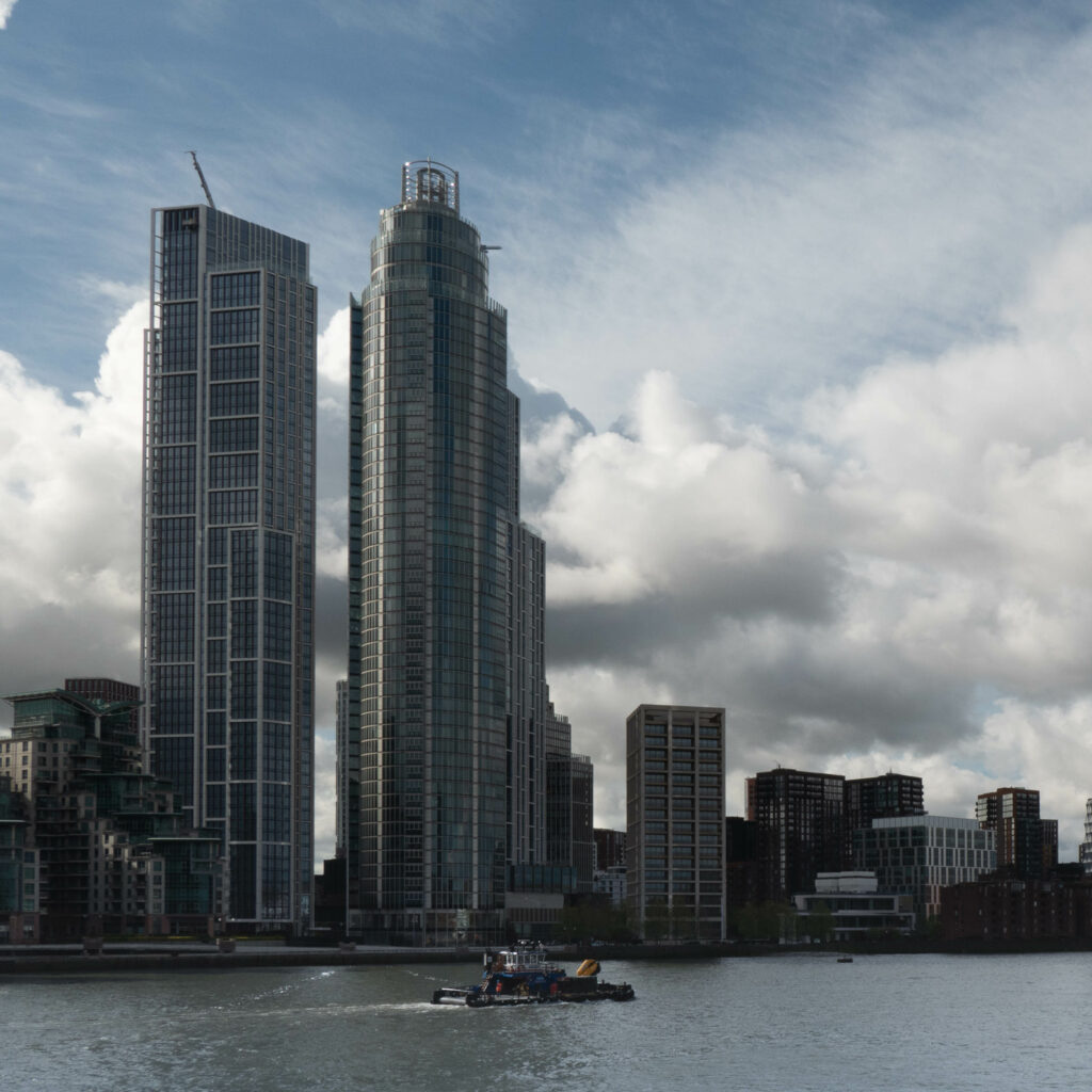 Serene Cityscape Wallpaper: Skyscrapers, Waterfront & Dramatic Sky