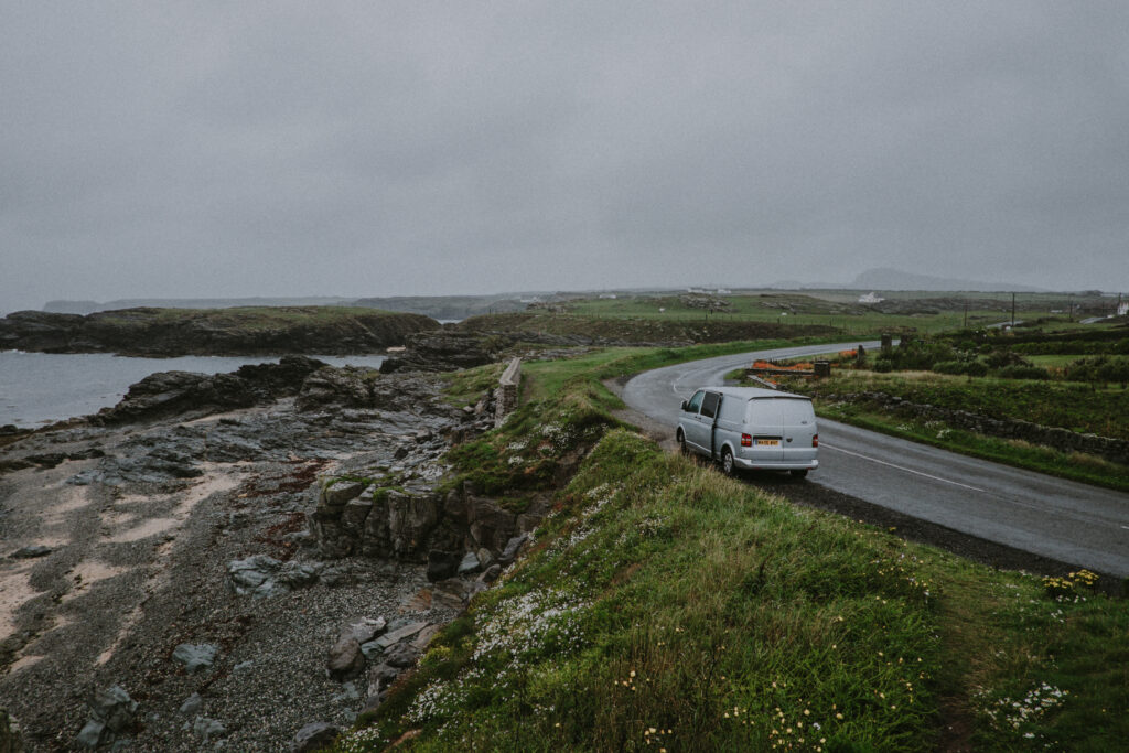 Serene Coastal Wallpaper with Scenic Road and Rugged Cliffs
