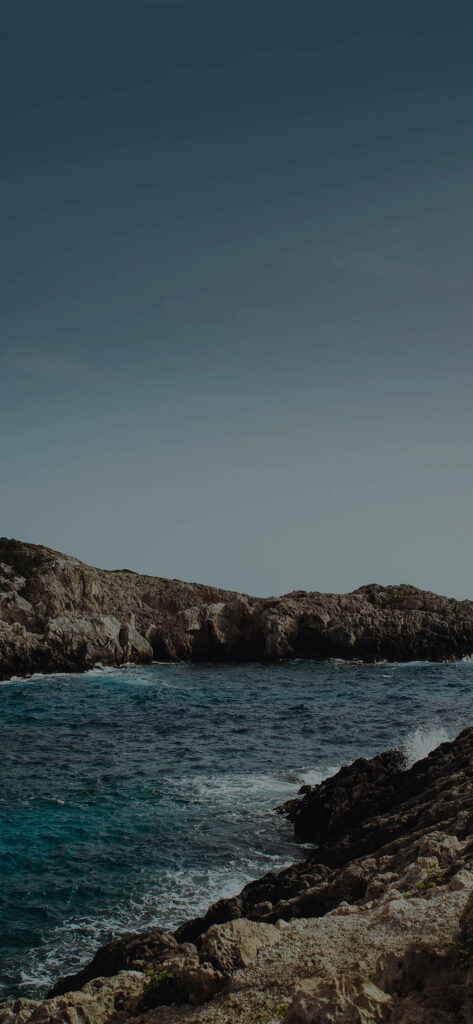 Serene Coastal Wallpaper: Rugged Cliffs & Blue Ocean Background