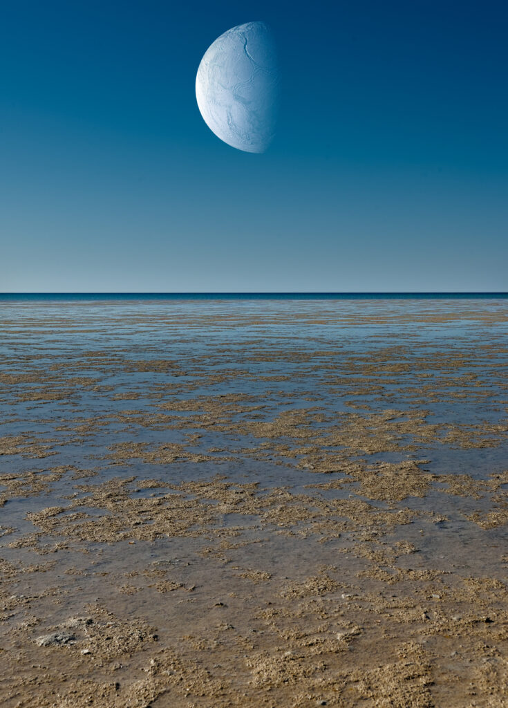 Surreal coastal wallpaper with shallow water and giant textured planet rising under clear sky