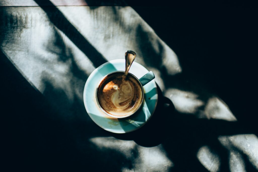Cozy Coffee Wallpaper: Serene Cup with Rich Foam in Soft Light