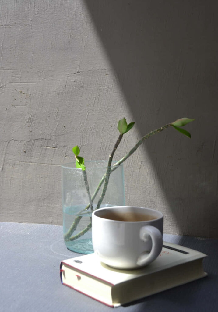 Serene Coffee and Book Scene with Minimalist Decor in Natural Light Wallpaper