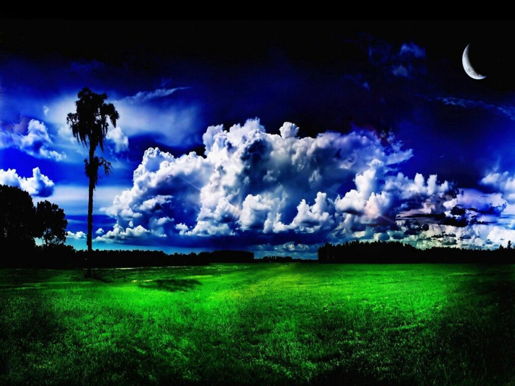 Vibrant green meadow under dramatic cloudy sky with silhouetted tree and crescent moon wallpaper