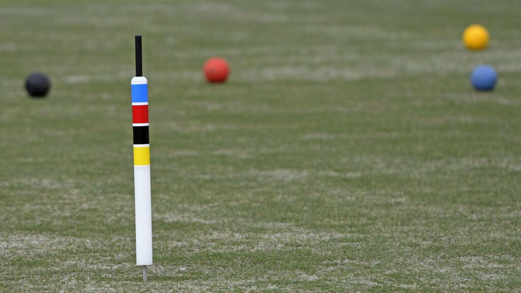 Vibrant Croquet Balls on a Serene Field - Perfect Wallpaper Background