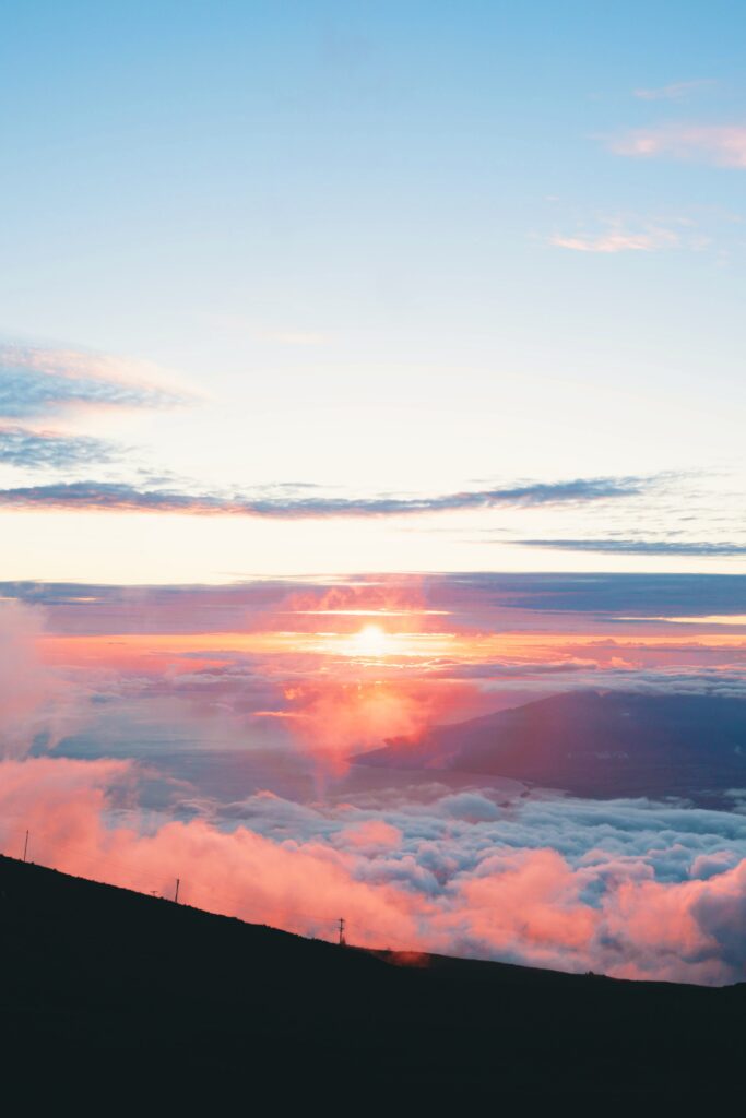 Aerial dawn view with soft pink orange and blue clouds creating a calm inspiring sky wallpaper
