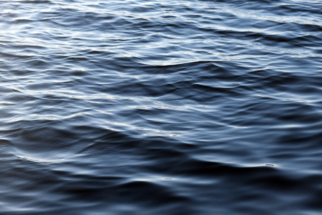 Realistic wallpaper of serene deep blue sea with gentle waves and natural water patterns