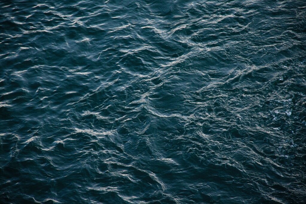 Serene deep blue sea wallpaper with textured waves and gentle ripples for calming backgrounds