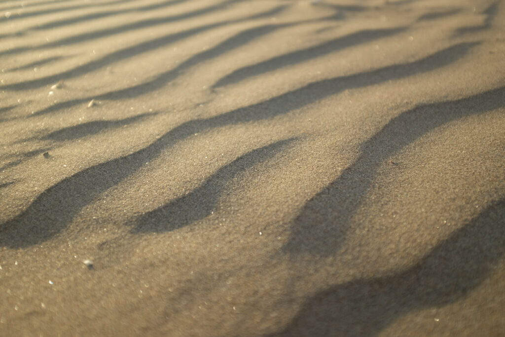 Textured Desert Sand Wallpaper: Close-Up Ripples & Shadows